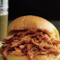 Bbq Pulled Chicken Sandwich · Juicy pulled chicken with house BBQ sauce on fresh bread with your choice of two sides.