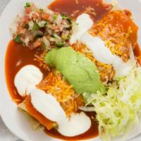 Asada  · Meat, beans and rice inside a burrito cover in red enchilada sauce with guacamole, sour crea...
