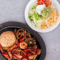 Fajitas · Sizzling peppers and onions, served with Mexican rice, shredded lettuce, cheddar jack cheese...