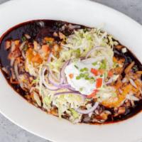 Enchiladas · With red, green, black or mole; two corn tortillas stuffed with meat and cheese, baked in on...