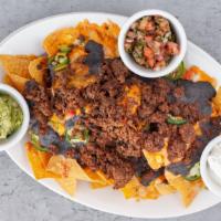 Supreme Nachos · Loaded with cheddar jack cheese, roasted corn, black bean salsa, tomato, scallion and jalape...
