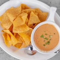 Queso & Corn Chips · Add chorizo for for an additional charge.