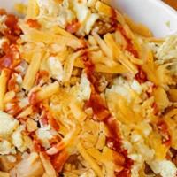 Breakfast Bowl. · Scrambled egg, potatoes, and cheddar cheese, topped with hot sauce