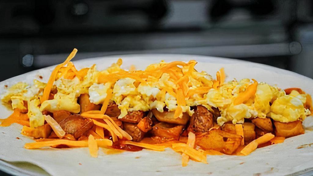 Breakfast Burrito · Scrambled egg, potatoes, and cheddar cheese, topped with hot sauce, and wrapped in a flour tortilla