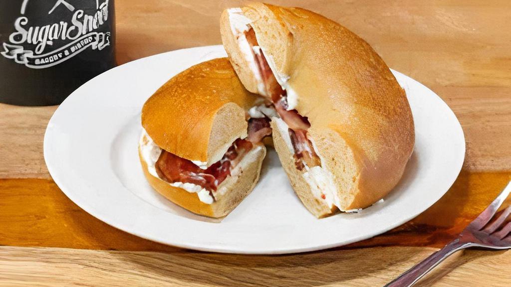 Breakfast Bagel · Fresh bagel of your choice toasted with your choice of ham, bacon sausage, or veggie sausage 
and cream cheese