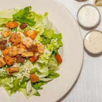 Caesar · Romaine lettuce tossed in caesar dressing and topped with croutons and shredded Parmesan che...