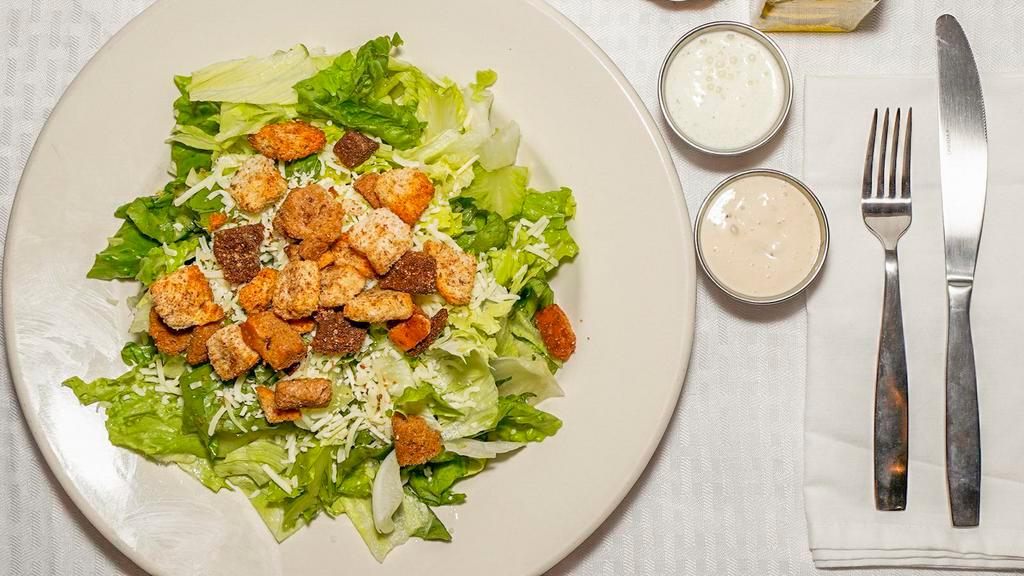 Caesar · Romaine lettuce tossed in caesar dressing and topped with croutons and shredded Parmesan cheese.