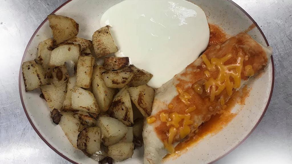 Breakfast Burrito · Flour tortilla stuffed with eggs, cheese, choice of chorizo, bacon, ham, or sausage topped with ranchera sauce, and choice of home fries or casamiento, with sour cream.