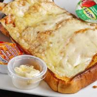 Monte Cristo · French toast topped with ham, turkey and melted Swiss, side of applesauce.