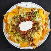 Nachos With Meat / Nachos Con Carne · Choice of meats: al pastor, steak, chicken, sausage / al pastor, asada, pollo, chorizo.