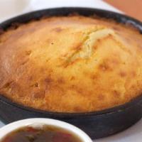 Cornbread · Baked in a cast iron skillet to order with a side of sweet pepper jam