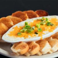 Hot Crab Dip · Savory blend of lump crab meat, cream cheese, and spices topped with cheddar and melted unti...
