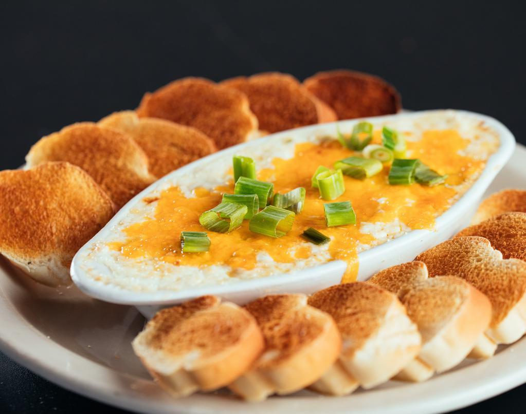 Hot Crab Dip · Savory blend of lump crab meat, cream cheese, and spices topped with cheddar and melted until hot and bubbly