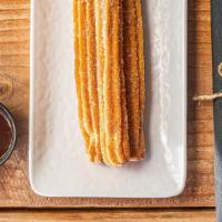 Churros · Churros with chocolate dipping sauce.