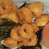 Fried Calamari · With cocktail sauce. Breaded and fried squid rings served with cocktail and lemon on side.