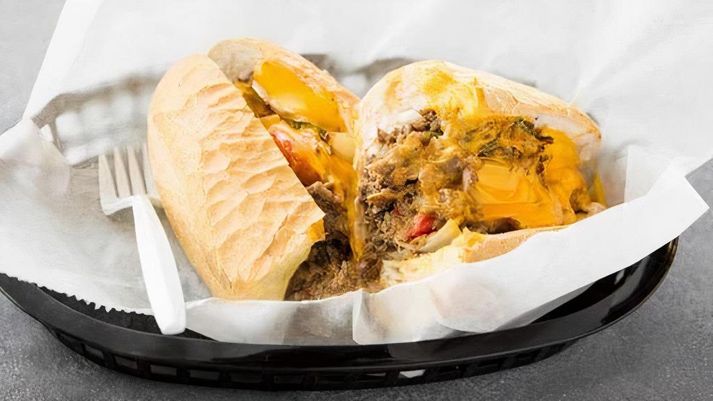 The Philly Cheesesteak · Steak or chicken, cheese, fried onions, red peppers, and green peppers.