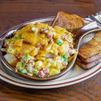 Skillet Breakfast · Scrambled eggs, potatoes, ham, onion, green pepper and cheddar cheese served with toast.