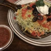 Chili Tostada · Tortilla chips topped with chili, onions, shredded lettuce, cheese, tomato, olives and sour ...