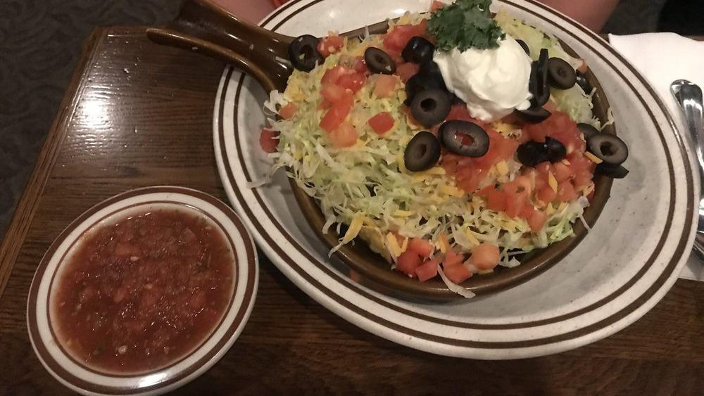 Chili Tostada · Tortilla chips topped with chili, onions, shredded lettuce, cheese, tomato, olives and sour cream. Served with salsa.