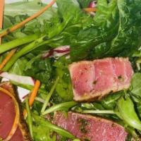Ahi Tuna Salad · Spiced & seared tuna steak, avocado, spinach leaves, arugula , grilled scallions, basil pest...