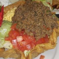 Taco Salad · Your choice of ground beef or shredded chicken topped with lettuce, tomatoes, and cheese in ...