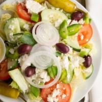 Greek Salad · Crisp lettuce, tomatoes, cucumbers, green peppers, onions, feta cheese, peppers, and kalamat...