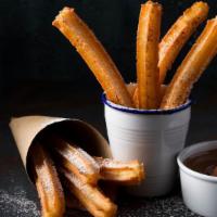 Mexican Caramel Churros · Fresh deep fried churro coated in cinnamon sugar and filled with a mexican caramel (dulce de...