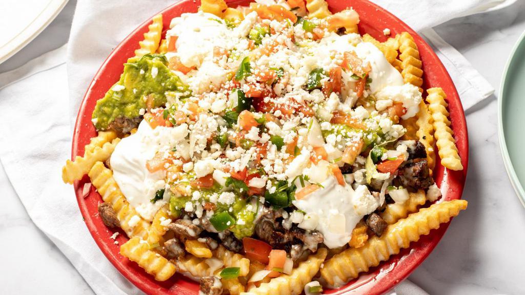 Mexican Steak Fries · French fries topped with grilled steak, guacamole, pico de gallo, sour cream, cheese dip and queso fresco.