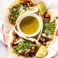 Tacos Al Pastor · Three marinated pork tacos. Served with cilantro and onions