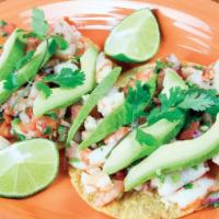 Shrimp Tostadas · Two shrimp tostadas served with avocado slices and pico de gallo