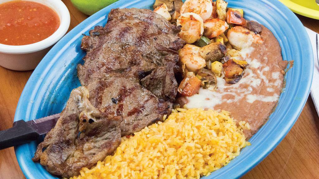 Steak & Shrimp · A great combination of grilled steak and shrimp, with bell peppers, mushrooms, onions, squash and tomatoes. Served with Mexican rice, and beans and tortillas.