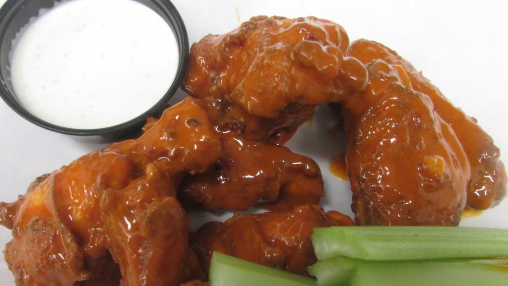 Buffalo Wings · Fried chicken wings tossed in buffalo sauce served with choice of dip