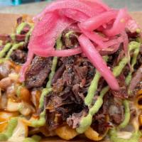 Bbq Frito Pie · Fritos topped with chili, pulled pork, bbq sauce, queso, salsa verde, & pickled onions
