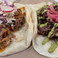 Taco Party · 1 brisket & 1 pulled pork taco on Flores beef fat flour tortillas. Choice of one side