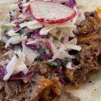 Pulled Pork · Smoked pulled pork with house made coleslaw, served on Flores beef fat flour tortilla