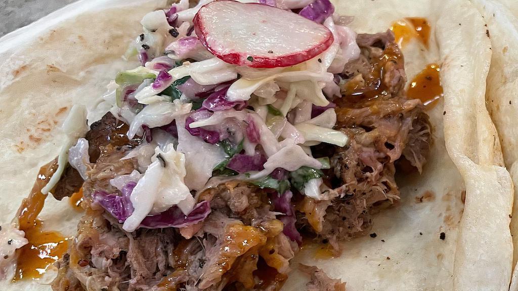 Pulled Pork · Smoked pulled pork with house made coleslaw, served on Flores beef fat flour tortilla