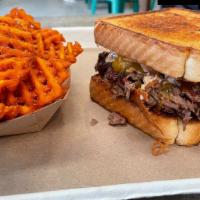 Brisket Patty Melt · Chopped brisket, topped with caramelized onions, cheddar cheese, and chipotle aioli on Texas...