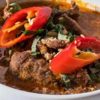 Beef Penang · Beef sautéed in spicy red curry sauce with basil leaves & kaffir lime leaves.