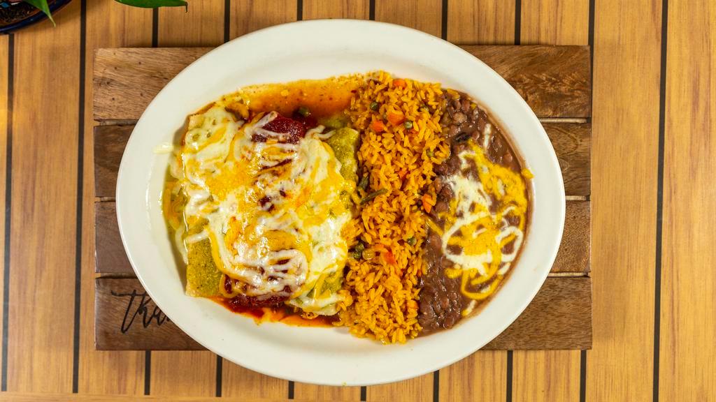 Shredded Chicken Enchiladas
 · Served with green tomatillo sauce. Two corn tortillas rolled with preference, topped with salsa and covered with cheese. Served with Mexican rice, refried beans, guacamole, sour cream, and pico de gallo on the side.