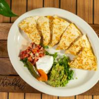 Grilled Chicken Quesadillas
 · Flour tortilla stuffed with cheese, grilled until golden brown. Served with guacamole, sour ...