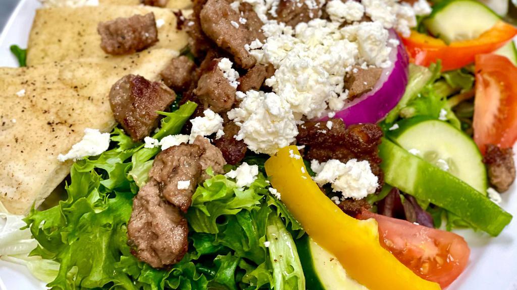 Greek Salad · Fresh garden greens with tomato, cucumber, red onion, mixed sweet peppers, kalamata olives, pepperoncini and feta cheese, served with yia yia's dressing and pita.