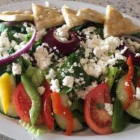 Greek Village Salad · A variety of tomatoes, cucumber, red onions, mixed sweet peppers, chickpeas, kalamata olives...