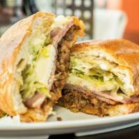 Torta Cubana · Choose your meat. Served with ham, queso fresco and soda.
