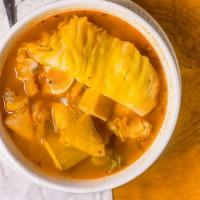 Sopa De Mondongo · A traditional Salvadoran soup served with beef tripe, plantains, cassava, cabbage, corn, and...
