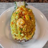 Pineapple Fried Rice · Pineapple, shrimp, chicken and fried rice with Thai flavor served in a pineapple shell. Hot ...