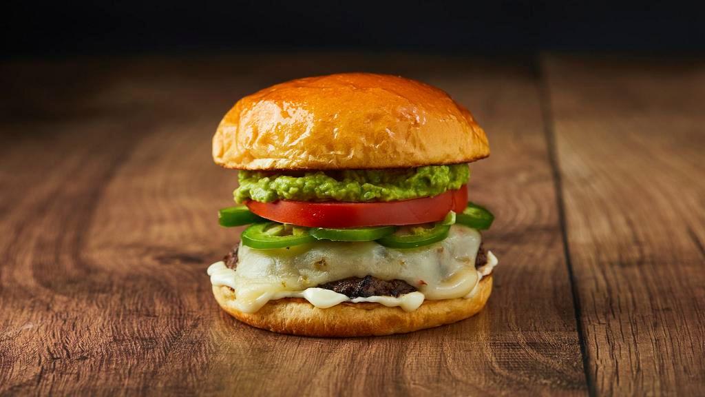 The Spicy Guacamole Burger · Beef patty, jalapenos, tomato, guacamole, and melted pepper jack cheese on a brioche bun.