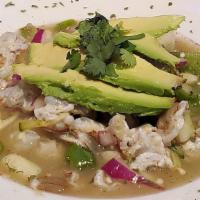 Aguachiles · Shrimp submerged in lime juice, serrano peppers, salt, cilantro, cucumber, and onion.(Raw se...