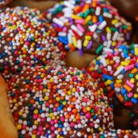 1 Dz Sprinkle Holes · 1 dz chocolate glazed and sprinkle topped donut holes.