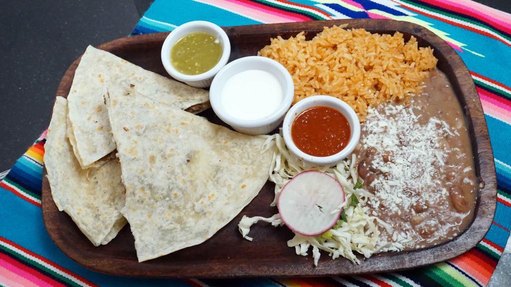 Quesadilla Nortena · Asada, ai pastor, chorizo or pollo, flour tortilla filled with melted cheese and your choice of meat. Served with rice, beans, Mexican sour cream, green and red salsa.