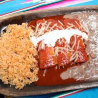 Enchiladas De Queso (3) · Corn tortillas filled with cheese and smothered with red guajillo enchilada sauce, topped wi...